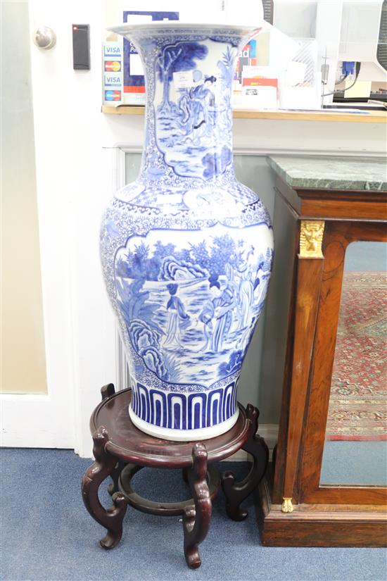 A massive Chinese blue and white vase and wood stand